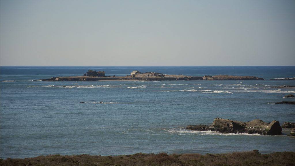 Low island with a few small buildings